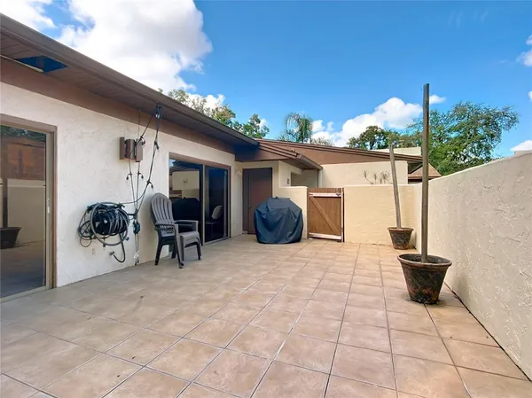 a view of a patio with table and chairs and potted plants