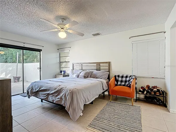 a bedroom with a bed and a couch