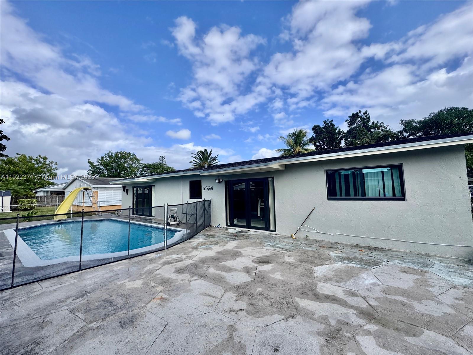 19720 Southwest 118th Place Miami, FL 33177 - Photo 11 of 21 a view of house with yard and entertaining space
