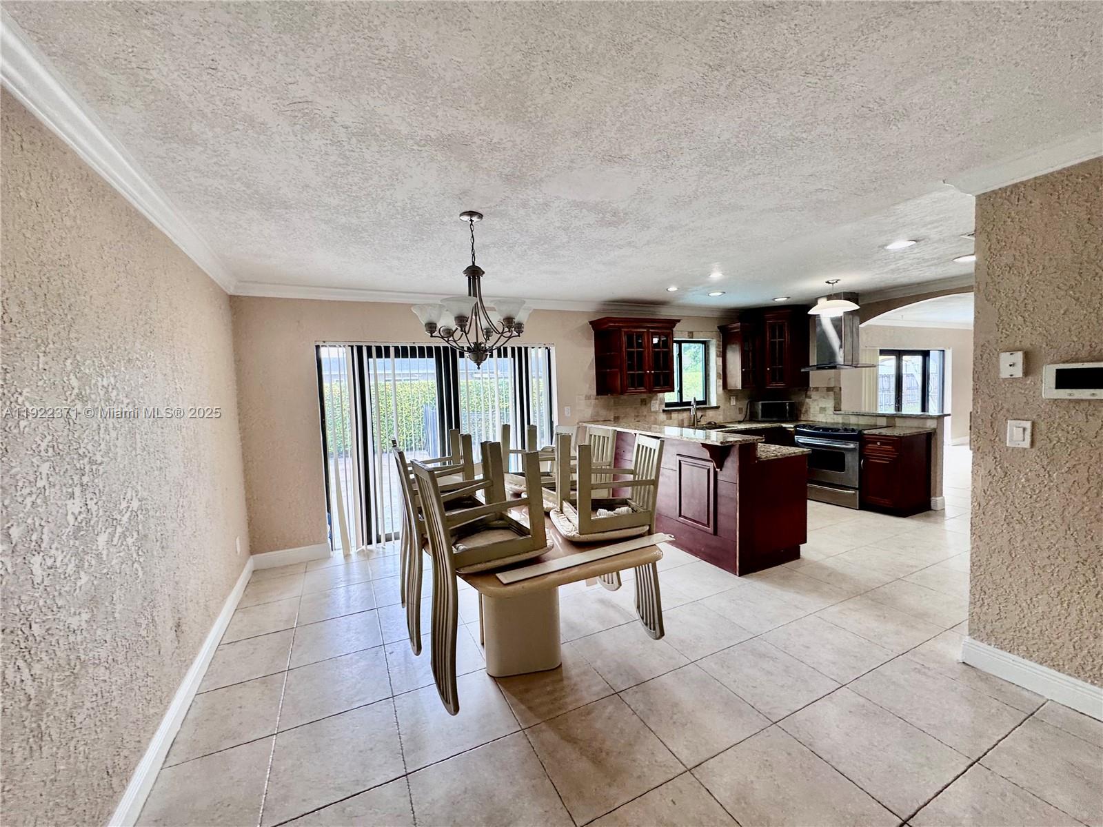 19720 Southwest 118th Place Miami, FL 33177 - Photo 18 of 21 a kitchen with stainless steel appliances kitchen island granite countertop a sink and cabinets