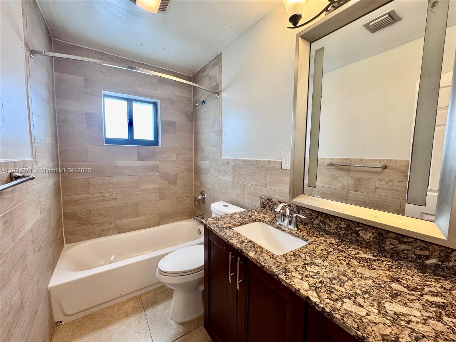 19720 Southwest 118th Place Miami, FL 33177 - Photo 7 of 21 a bathroom with a granite countertop sink toilet and shower