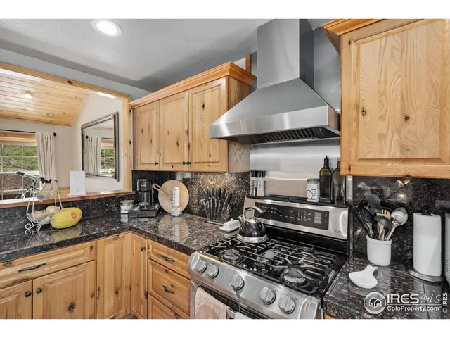 a kitchen with stainless steel appliances granite countertop a stove and a sink