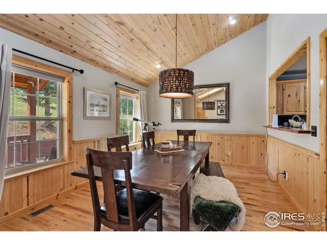 a view of a dining room with furniture and a window