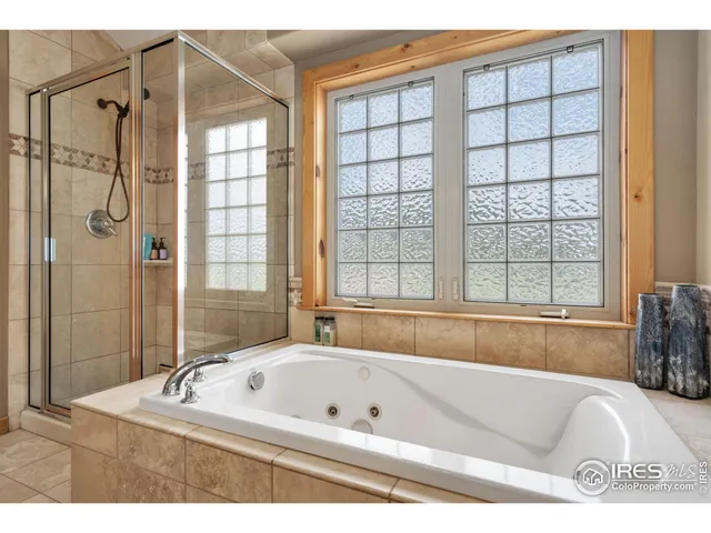 a bathroom with a bathtub and a shower