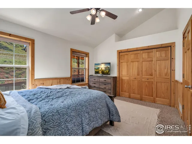 a bedroom with a bed dresser and a window