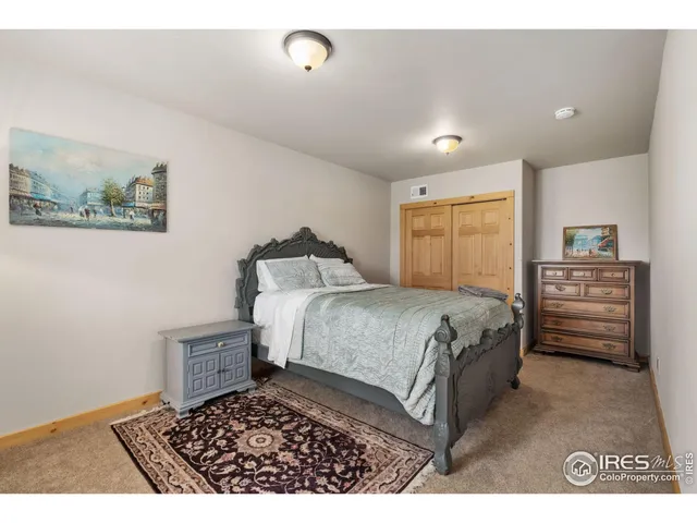 a bedroom with a bed and a view of kitchen
