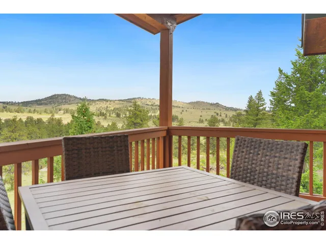 a view of balcony with wooden floor and mountain view