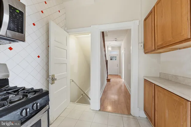 a kitchen with granite countertop a stove and a sink