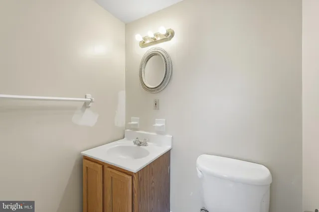a bathroom with a toilet a sink and a mirror