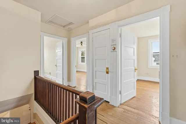 a view of a hallway with wooden floor and entryway