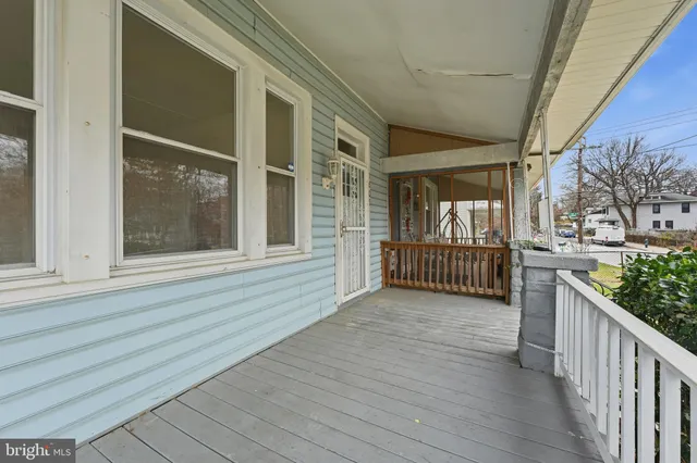 a view of a porch with wooden floor and fence