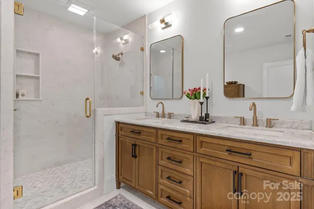 a bathroom with double sink and a mirror