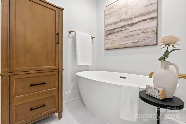 a bathroom with a bathtub and a window