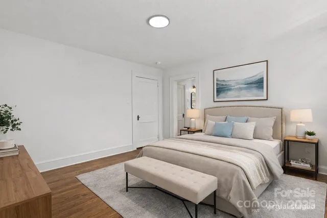 a bedroom with a bed and a painting on the wall