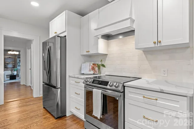 a kitchen with granite countertop cabinets stainless steel appliances and a counter space