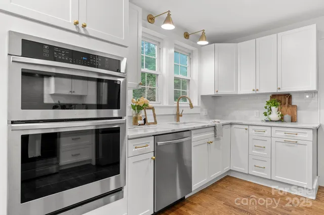 a kitchen with granite countertop cabinets stainless steel appliances and a counter space