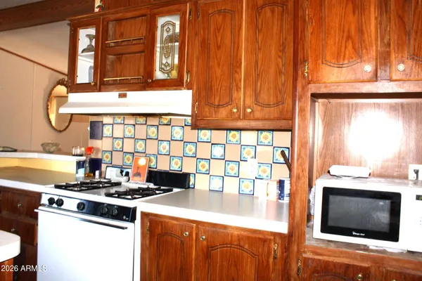 a kitchen with stainless steel appliances granite countertop a stove and a microwave