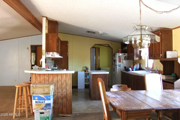 a view of a dining room with furniture and chandelier