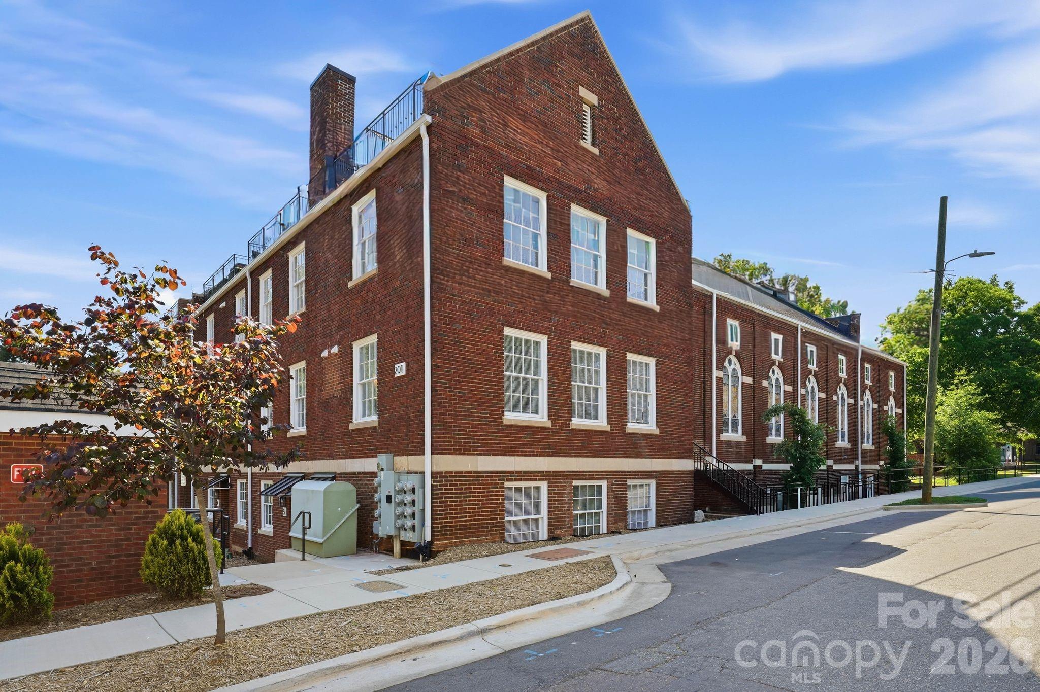 201 Grandin Road, Unit 6 Charlotte, NC 28208 - Photo 28 of 45 a front view of a building with street view and trees