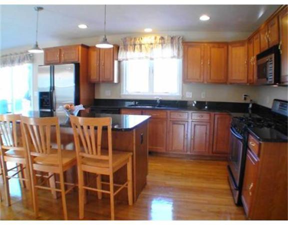 64 Clark Road Shirley, MA 01464 - Photo 6 of 25 a kitchen with stainless steel appliances granite countertop a stove a sink a refrigerator white cabinets and wooden floor