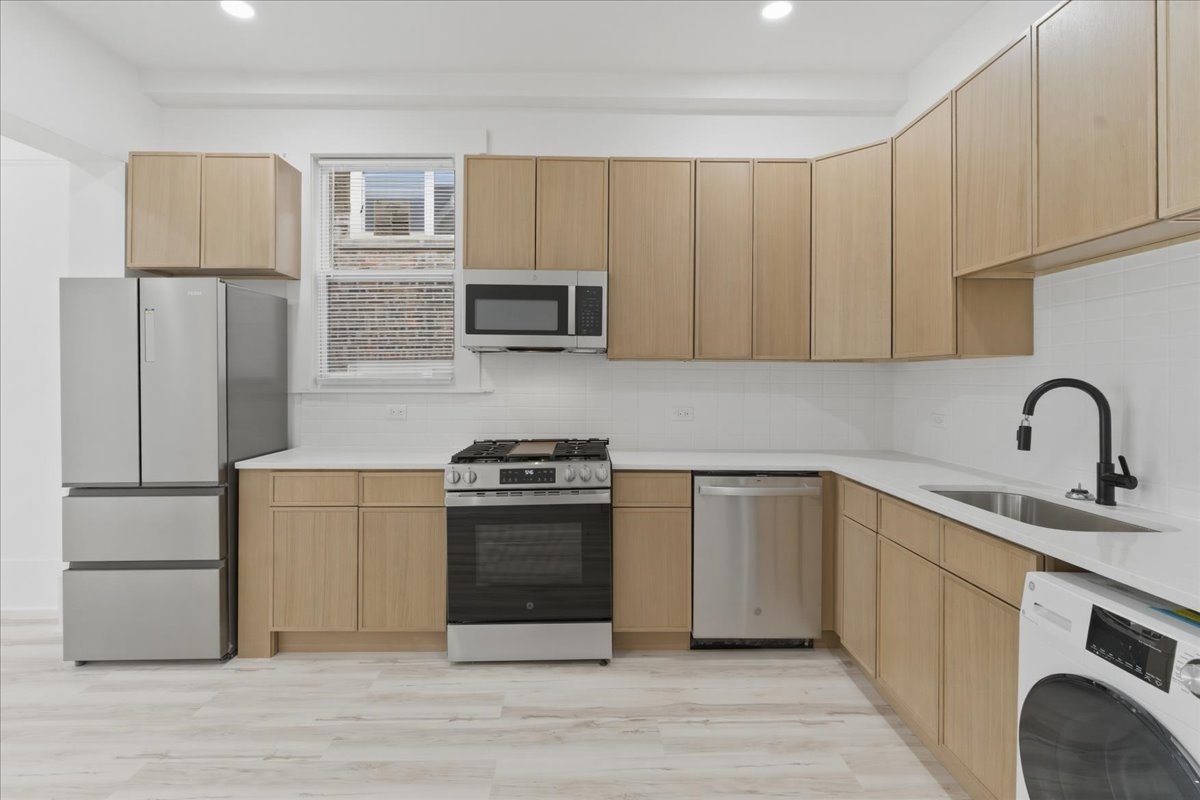 2607 West Haddon Avenue, Unit 2F Chicago, IL 60622 - Photo 4 of 12 a kitchen with a sink cabinets and stainless steel appliances