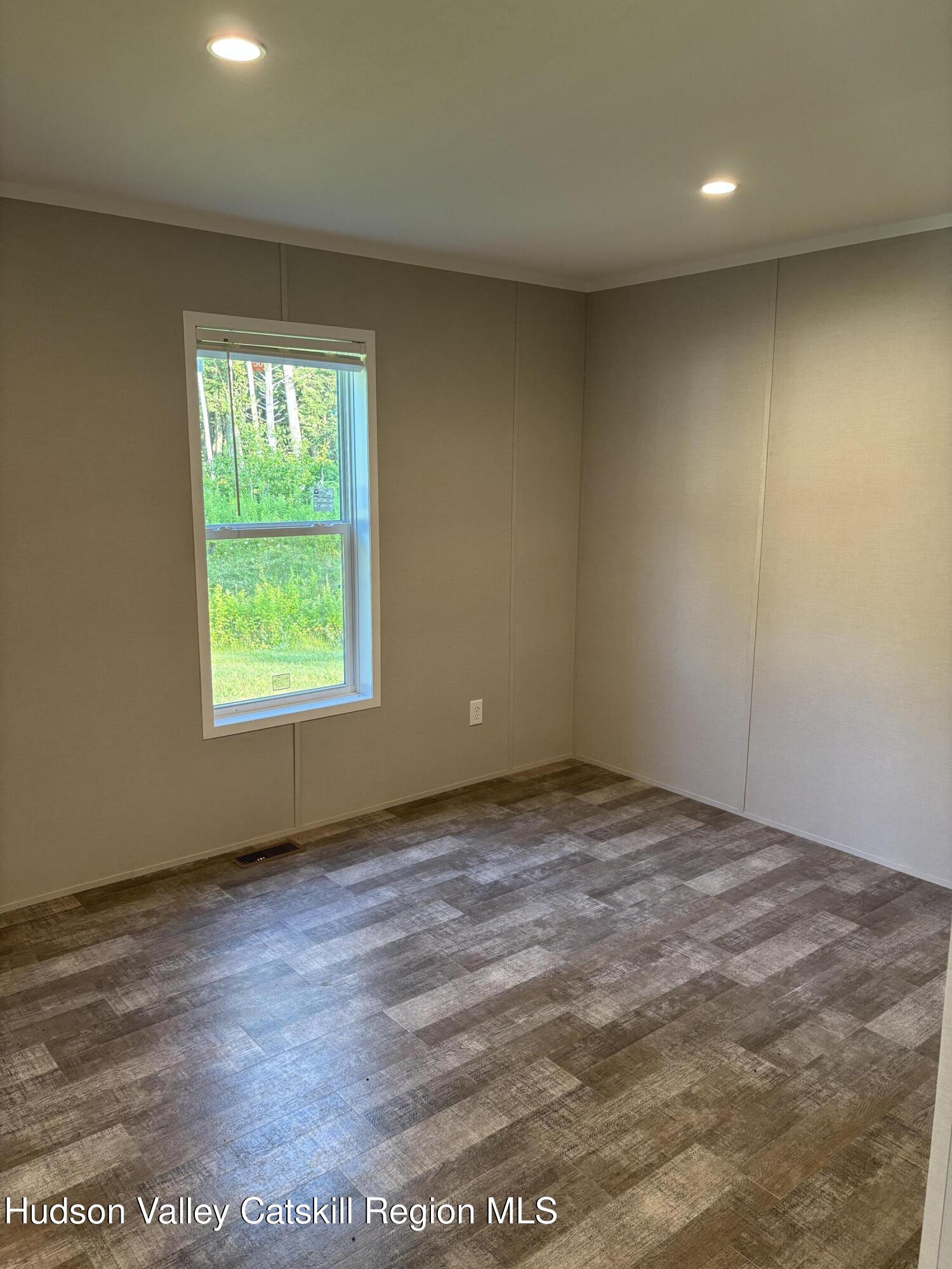20 Mt View Way Stephentown, NY 12168 - Photo 9 of 14 an empty room with wooden floor and windows