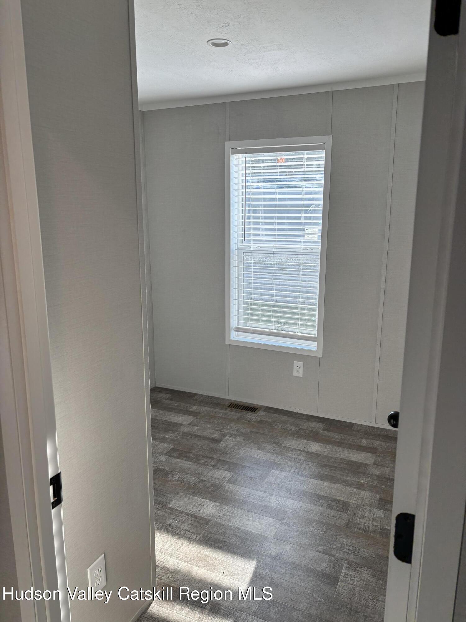 20 Mt View Way Stephentown, NY 12168 - Photo 10 of 14 a view of an empty room with wooden floor and a window