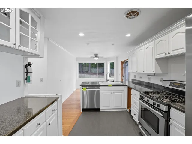 a kitchen with stainless steel appliances granite countertop a stove and a sink