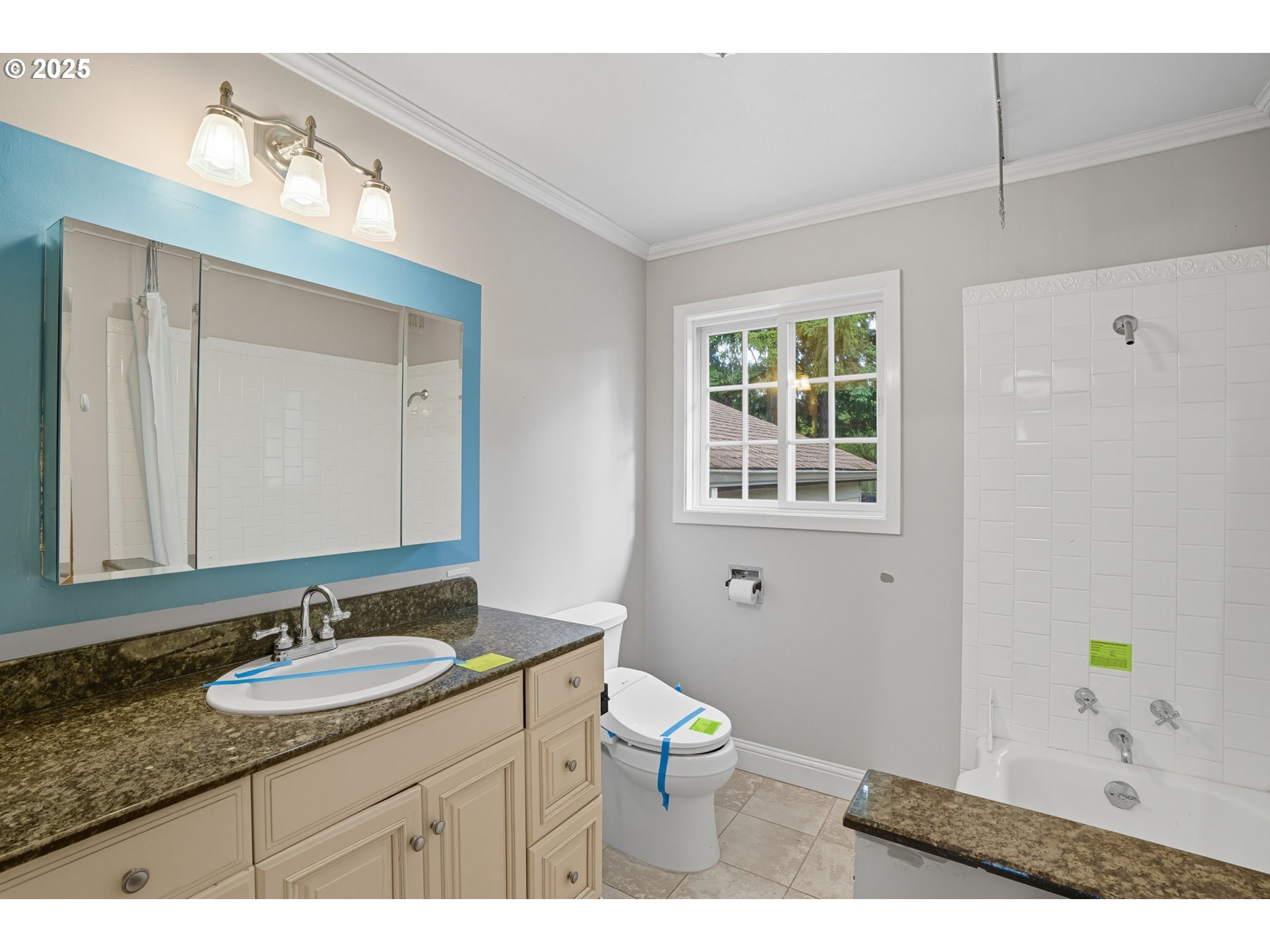 9360 Southwest Meadow Lane Portland, OR 97225 - Photo 21 of 48 a bathroom with a granite countertop sink a toilet and a mirror