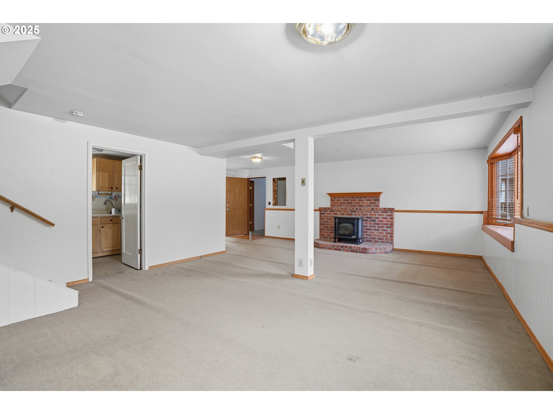 9360 Southwest Meadow Lane Portland, OR 97225 - Photo 25 of 48 a view of empty room with a fireplace