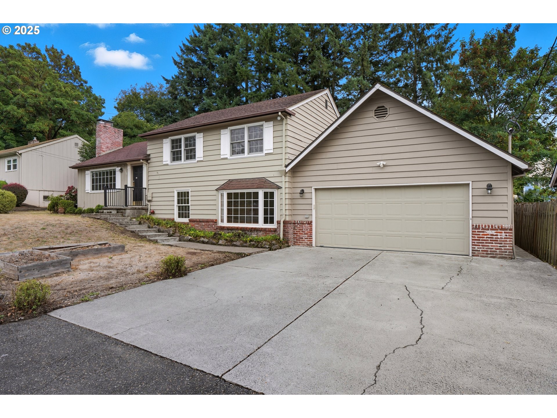 9360 Southwest Meadow Lane Portland, OR 97225 - Photo 3 of 48 a view of a house with a yard and garage