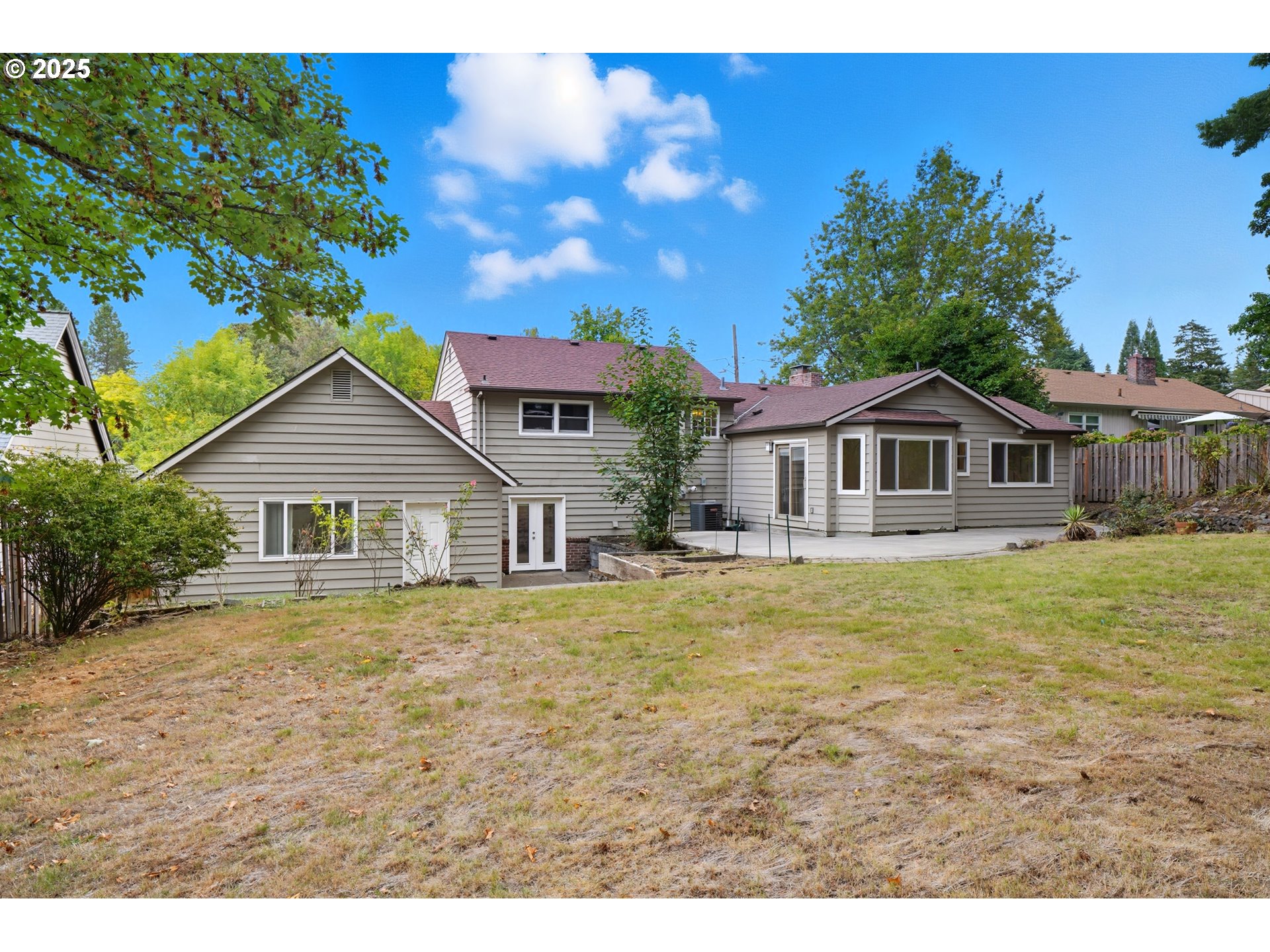 9360 Southwest Meadow Lane Portland, OR 97225 - Photo 32 of 48 a front view of a house with a garden