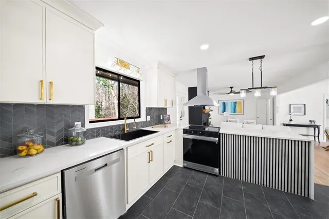 a kitchen with a sink stove and cabinets