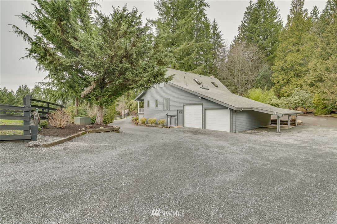 611 Newberg Road Snohomish, WA 98290 - Photo 4 of 40 a view of a house with a yard and garage