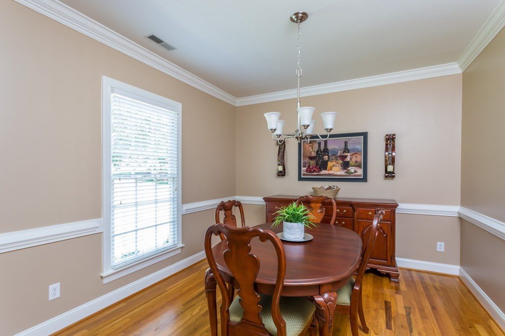 The dining room has gorgeous HARDWOODS, crown molding, chair rail and plenty of space for quiet family dinners or entertaining guests. Dining Room