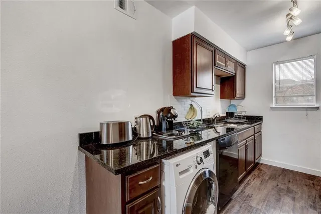 a kitchen with stainless steel appliances granite countertop a sink stove and microwave