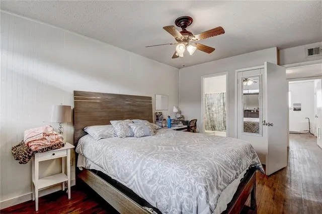a bedroom with a large bed and a chandelier