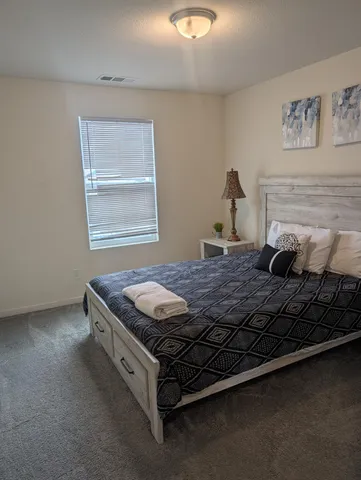 a bedroom with table and window