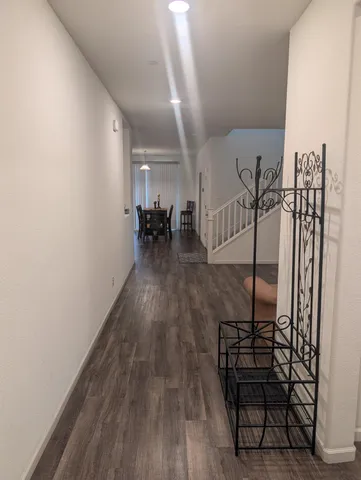 a view of a room with wooden floor and stairs