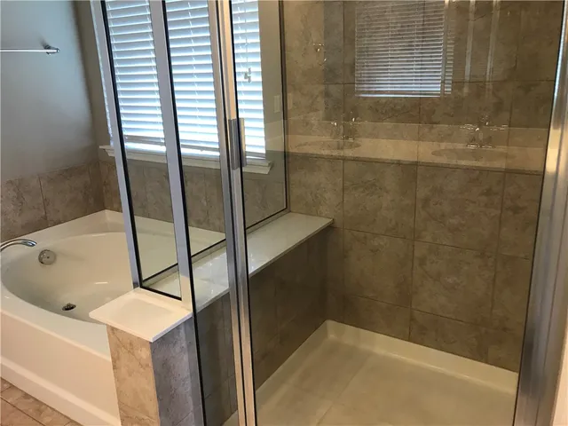 a bathroom with a bathtub and shower