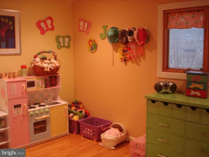 9213 Friars Road Bethesda, MD 20817 - Photo 11 of 15 a room with a baby bed and a dresser