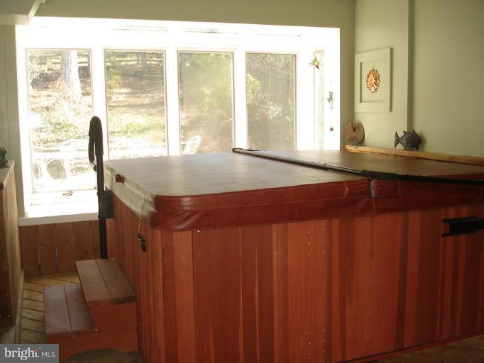 9213 Friars Road Bethesda, MD 20817 - Photo 14 of 15 a bathroom with a granite countertop sink and a large mirror next to a window