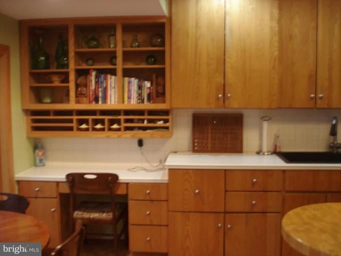 9213 Friars Road Bethesda, MD 20817 - Photo 5 of 15 a room with a chair and cabinets