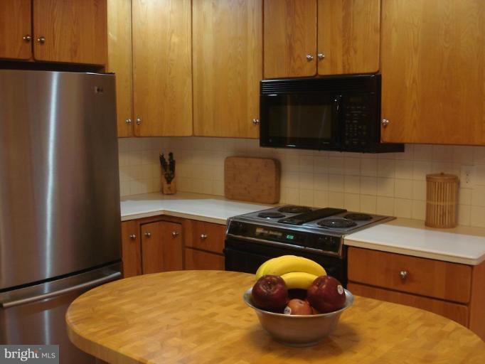 9213 Friars Road Bethesda, MD 20817 - Photo 6 of 15 a kitchen with a stove and a cabinet
