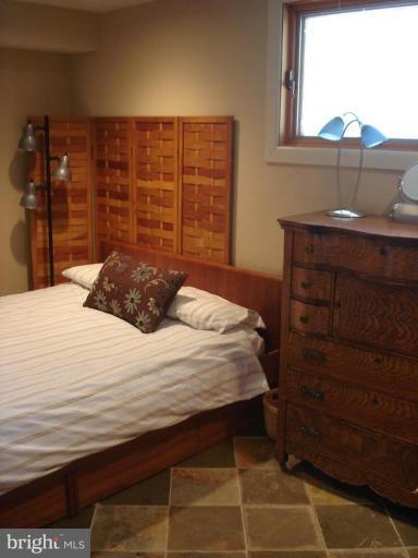 9213 Friars Road Bethesda, MD 20817 - Photo 9 of 15 a bedroom with a bed and a dresser