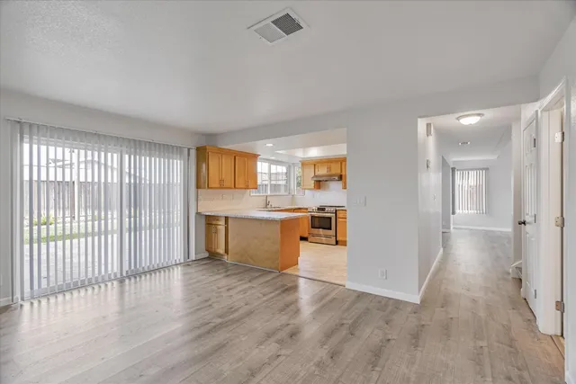 a view of a kitchen with wooden floor and a sink