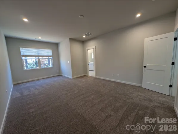 a view of an empty room and a window