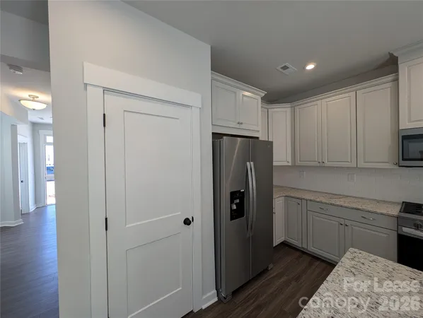 a kitchen with a refrigerator and a sink