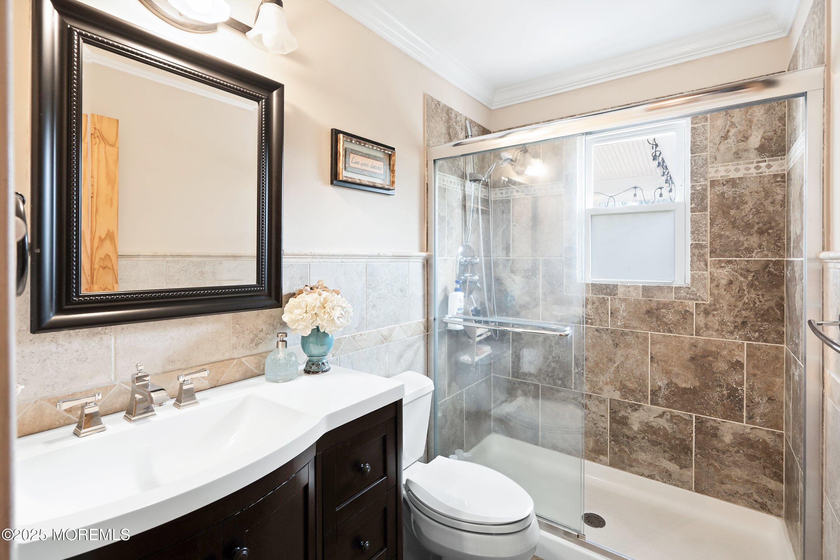 21 Drexel Drive Jackson, NJ 08527 - Photo 14 of 36 a bathroom with a sink a toilet and shower