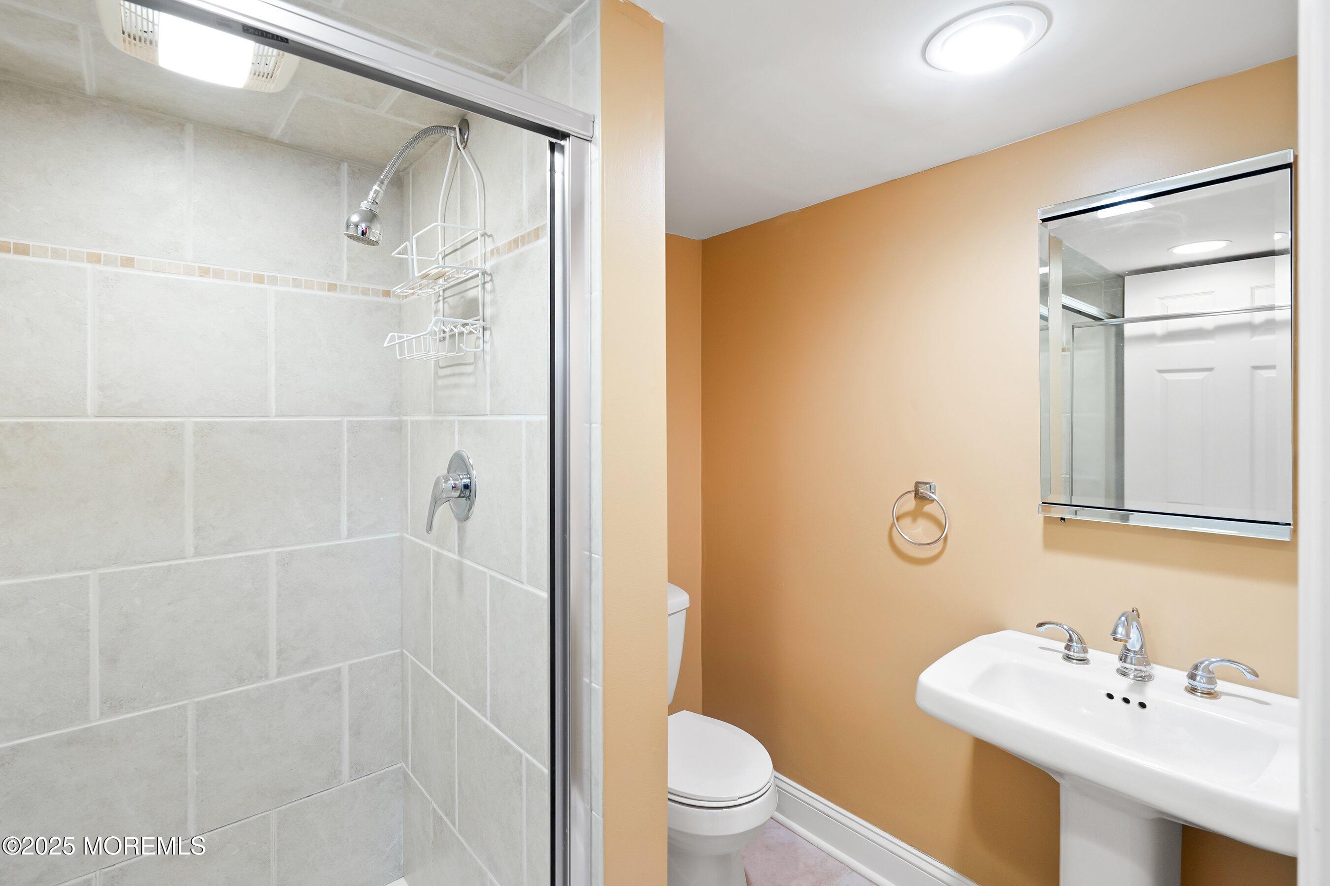 21 Drexel Drive Jackson, NJ 08527 - Photo 19 of 36 a bathroom with a sink mirror toilet and shower